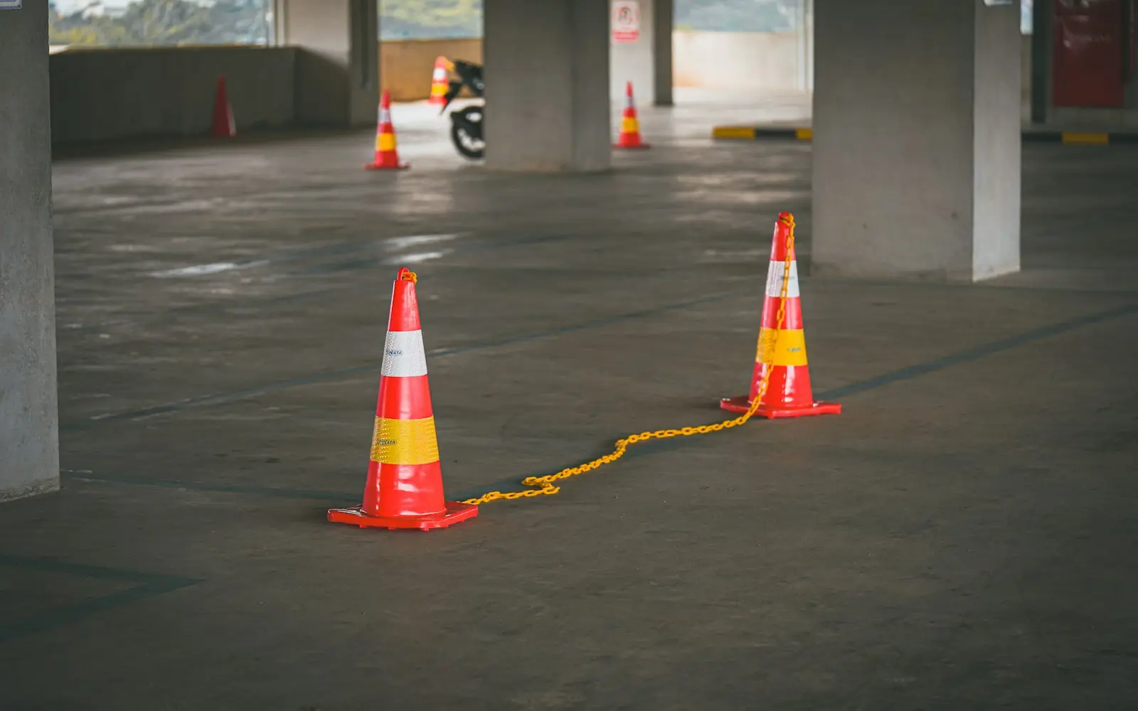Orange traffic cones and a chain closing off a lane